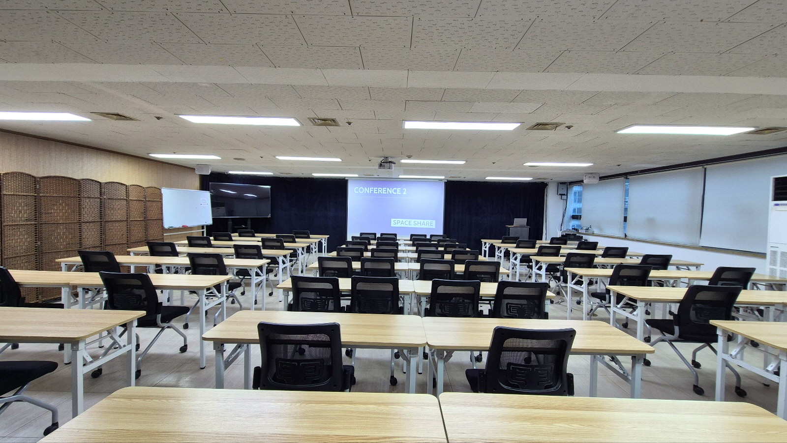 스페이스쉐어 지밸리센터 컨퍼런스2룸 정면, 대형 스크린과 음향 시설을 갖춘 강의장 전면